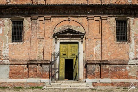 Fine art travel print of a weathered historic Italian brick facade with a vivid yellow green arched doorway and ironwork staircase, The Door Is Always Greener by Scott Allen Wilson, available in 8x12 and 16x24.