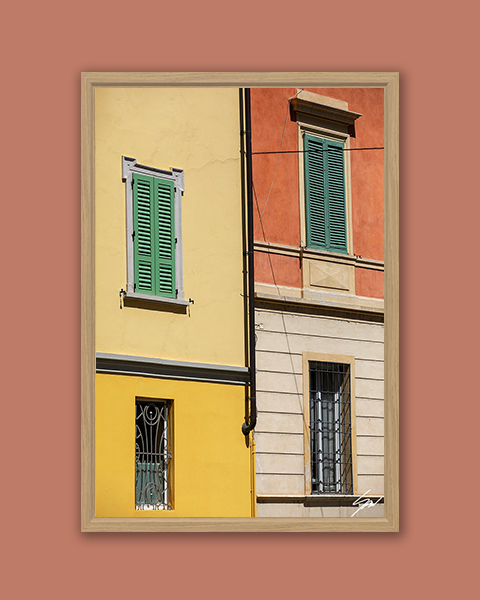 Fine art framed print of vibrant yellow and terracotta Italian building facades with green shuttered windows, The Colors of Cremona by Scott Allen Wilson, available in 8x12 and 16x24.