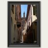 Fine art framed print of a colorful Italian alley with warm pastel facades and a historic rose window facade with copper spire at the end, Vibrance and Alleyways by Scott Allen Wilson, available in 8x12 and 16x24.