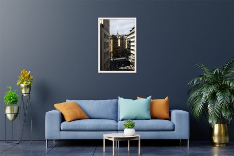 Scott Allen Wilson’s beautifully framed work of art showcasing Genova’s contrast between sunlight and its city streets, perfectly displayed in a blue modernly designed room.