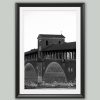 Black and white framed art print of the historic covered bridge in Pavia, Italy.