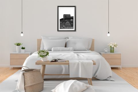Black and white framed art print of the historic covered bridge in Pavia, Italy.