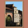 Framed travel art print of Pavia’s historic covered bridge captured in warm evening light.