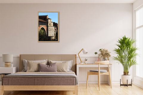 Framed travel art print of Pavia’s historic covered bridge captured in warm evening light.