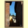Fine art travel photograph of light and shadow between historic buildings in Pavia.