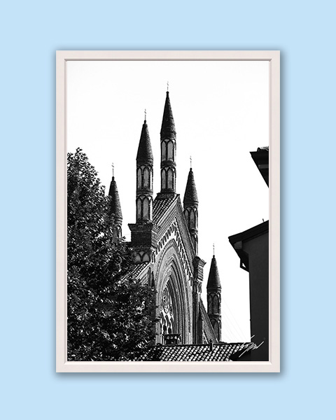 Black and white framed art print of gothic church spires rising above historic Pavia, Italy.