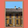 Framed travel art print of a mustard-colored facade in historic Pavia, Italy.