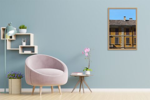 Framed travel art print of a mustard-colored facade in historic Pavia, Italy.