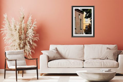 Framed travel art print of historic brick and faded facades in Pavia, Italy.