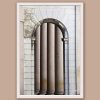 Framed travel art print of stone columns and an arched doorway in historic Pavia, Italy.