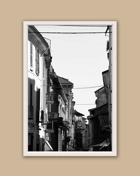 Framed B&W travel print featuring balconies, shadows, and urban textures in historic Italy.