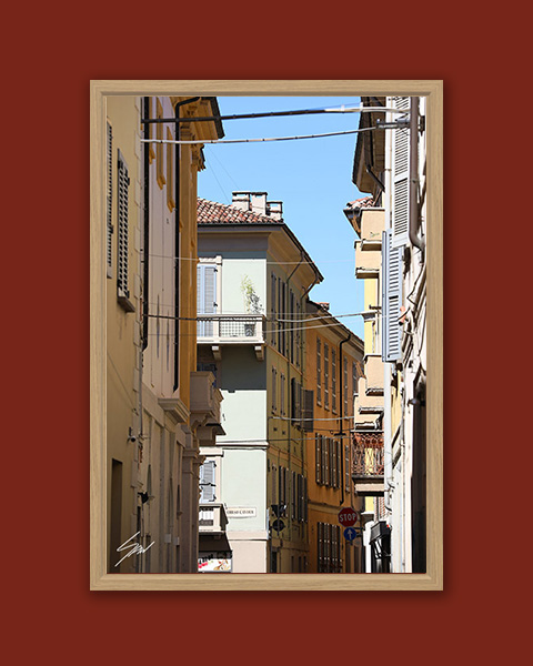 Fine art travel photograph capturing layered architecture, balconies, and overhead power lines in Pavia.