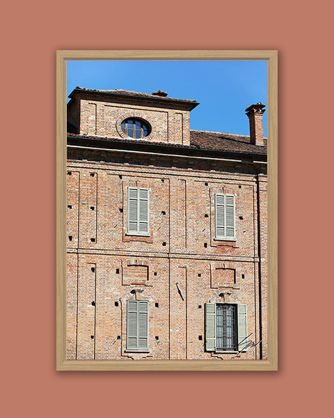 Framed travel art print of historic brick architecture and shuttered windows in Pavia, Italy.
