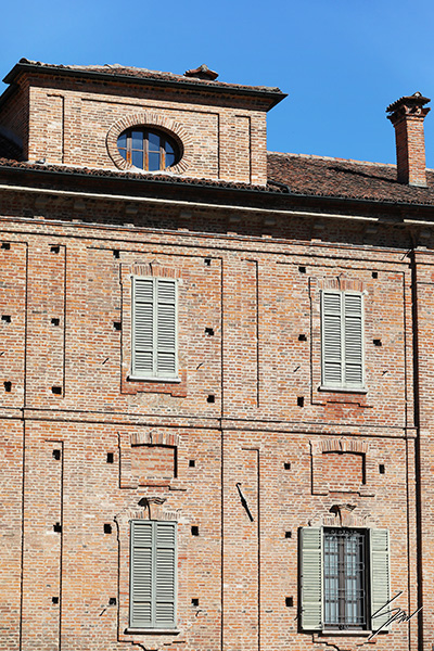 Framed travel art print of historic brick architecture and shuttered windows in Pavia, Italy.