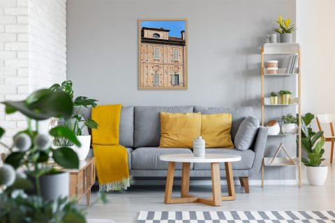 Framed travel art print of historic brick architecture and shuttered windows in Pavia, Italy.