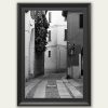 Framed black and white travel print featuring winding architecture and minimalist urban detail.