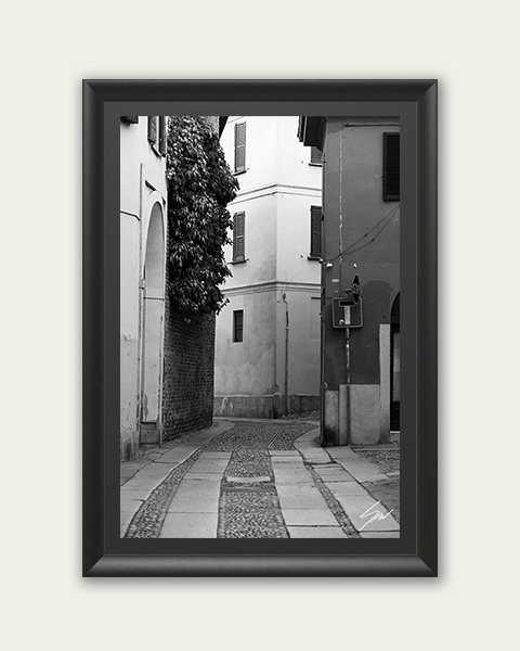 Framed black and white travel print featuring winding architecture and minimalist urban detail.