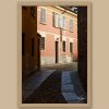 Fine art travel photograph capturing soft light, shadows, and quiet streets in Pavia.
