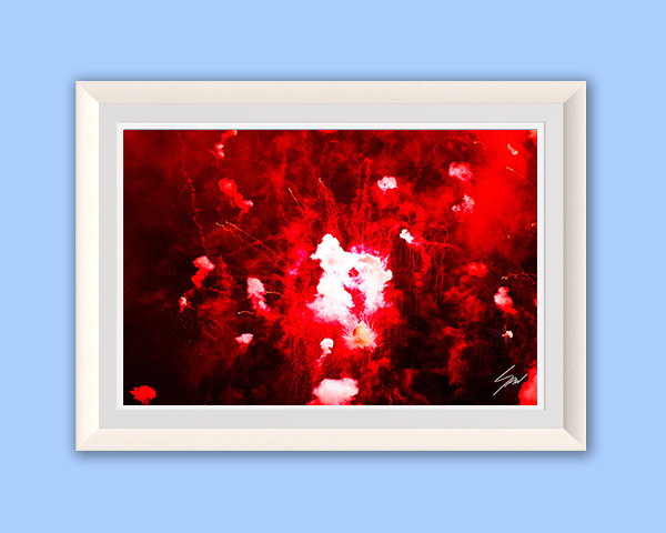 Framed abstract fine art print capturing an explosion of red fireworks and glowing smoke against the darkness of night.