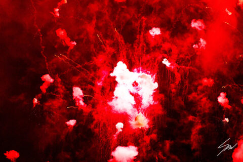 Framed abstract fine art print capturing an explosion of red fireworks and glowing smoke against the darkness of night.