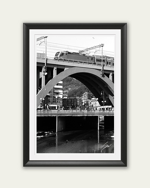 Travel fine art print featuring a railway bridge and passing train in monochrome, celebrating architecture, movement, and urban landscapes.