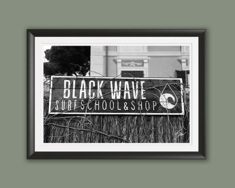 Travel fine art print featuring the Black Wave Surf School sign in monochrome, celebrating surf culture and the charm of the Italian coast.