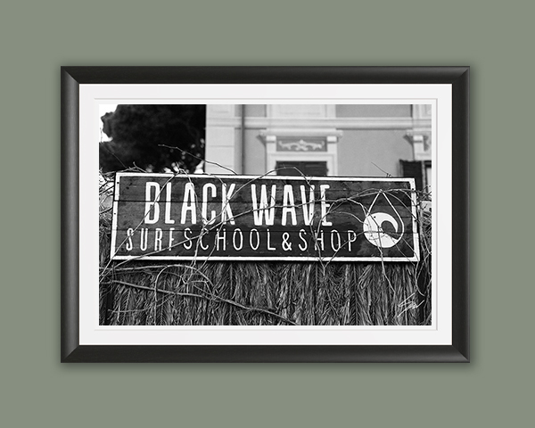 Travel fine art print featuring the Black Wave Surf School sign in monochrome, celebrating surf culture and the charm of the Italian coast.