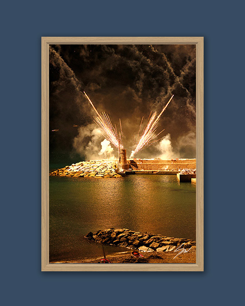 Vertical framed wall art featuring the illuminated lighthouse during the Sagra del Fuoco celebration in Recco, Italy.