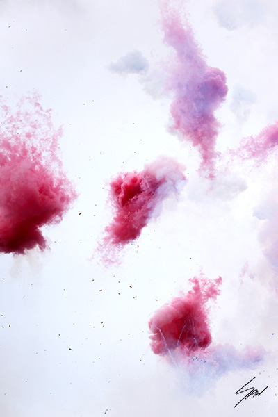 Abstract photograph of vivid pink smoke drifting through a bright white sky during an Italian festival celebration.