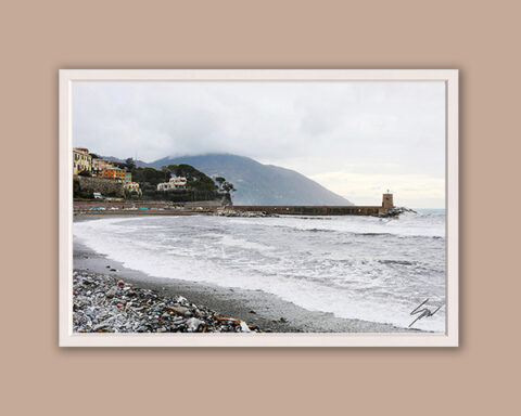 Photograph of Recco's coastline during the off season, with rolling waves, low clouds, and an empty beach.