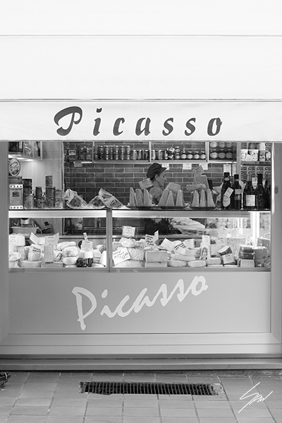 Monochrome travel photography print featuring the historic Picasso storefront, bringing authentic Italian charm and minimalist style to any interior.