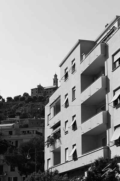 Monochrome architectural wall art capturing the dialogue between contemporary buildings and historic Italy in a timeless travel photograph.