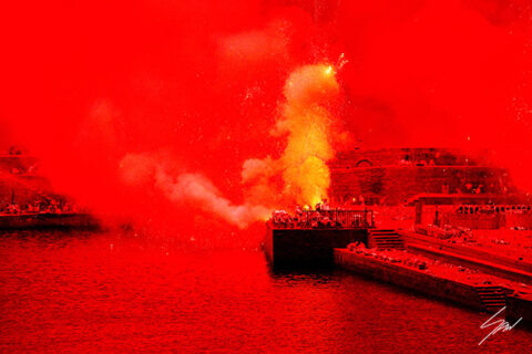 Framed fine art photography print of the Sagra del Fuoco lighting Recco Harbour in vivid red, displayed in a contemporary lounge.