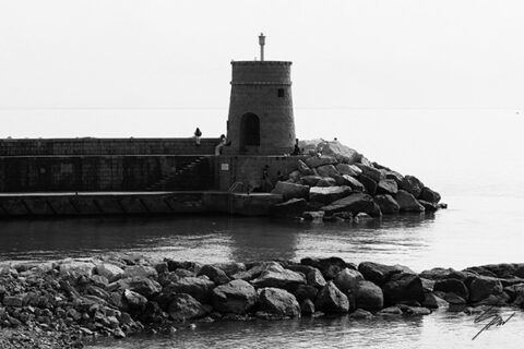 Black and white fine art photograph of Torretta, the historic lighthouse guarding the harbor on the Italian Riviera, bringing timeless coastal elegance to any space.
