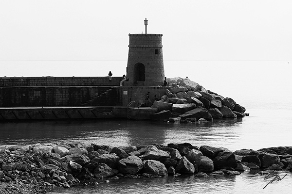 Black and white fine art photograph of Torretta, the historic lighthouse guarding the harbor on the Italian Riviera, bringing timeless coastal elegance to any space.