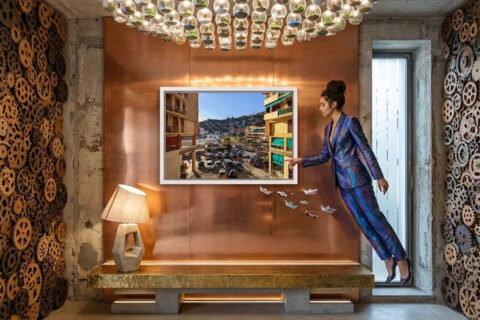 Framed fine art print overlooking the center of Recco from between apartment buildings, displayed in a contemporary interior.