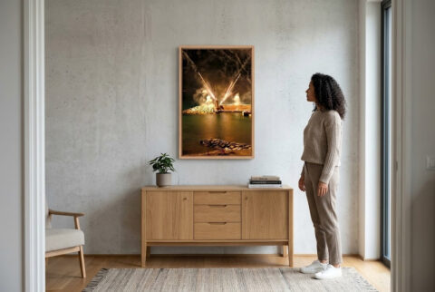 Framed fine art print of fireworks illuminating the lighthouse during Recco's Sagra del Fuoco, displayed in a modern home.