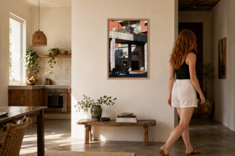 Framed fine art print of a quiet Recco street featuring the iconic Focaccia d'Autore bakery displayed in a warm modern home.